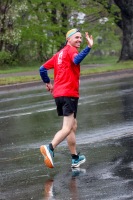 A runner waves while running
