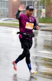 A runner waves to the camera