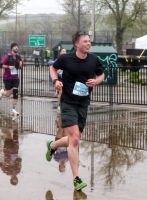 A young runner smiles as he runs