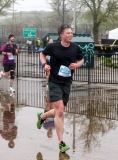 A young runner smiles as he runs