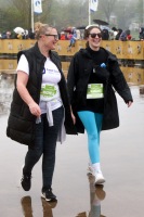 A pair laugh as they walk