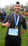 A man smiles and gives a thumbs up to the camera