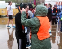 A runner smiles as they receive their medal.