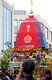 A man in a crowd looks at a chariot as it is pulled along Spring Garden Road..