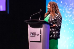 A woman speaking at the podium