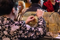 A women adds a raffle ticket the pot