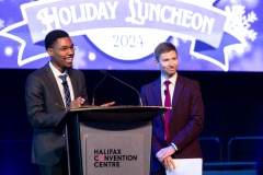 Two people at the podium smile to the crowd