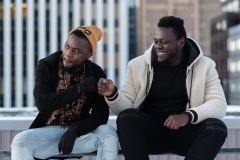 Two people fist bump and laugh amongst each other.